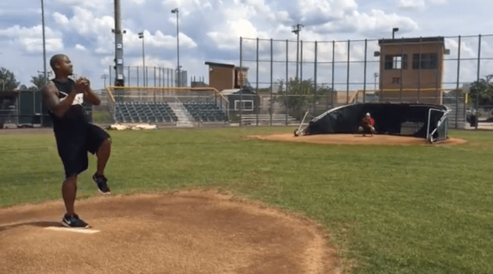 kris throws a baseball